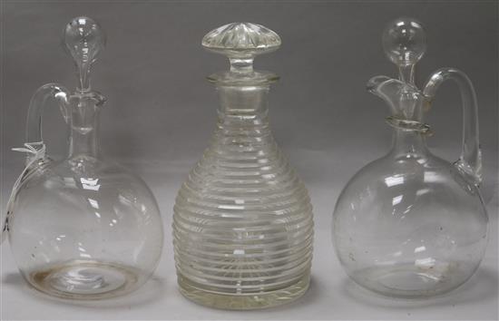 A 19th century step cut glass decanter and two glass hock or claret jugs tallest 24cm